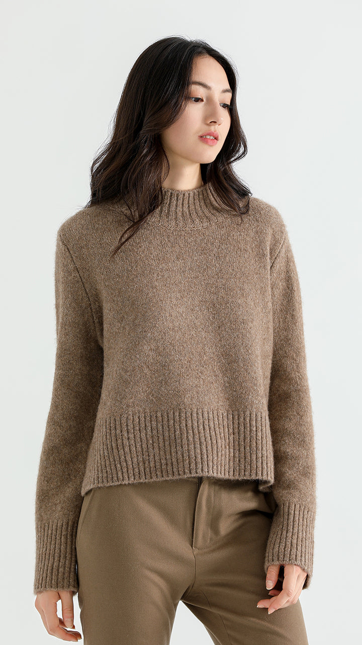 Elevate your wardrobe with the Above Land Cropped Sweater. Made from a luxurious yak wool blend, this stylish and cozy piece offers a relaxed fit, perfect for layering. A versatile design that combines comfort with modern flair.